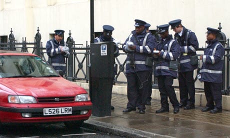 Traffic wardens issuing tickets